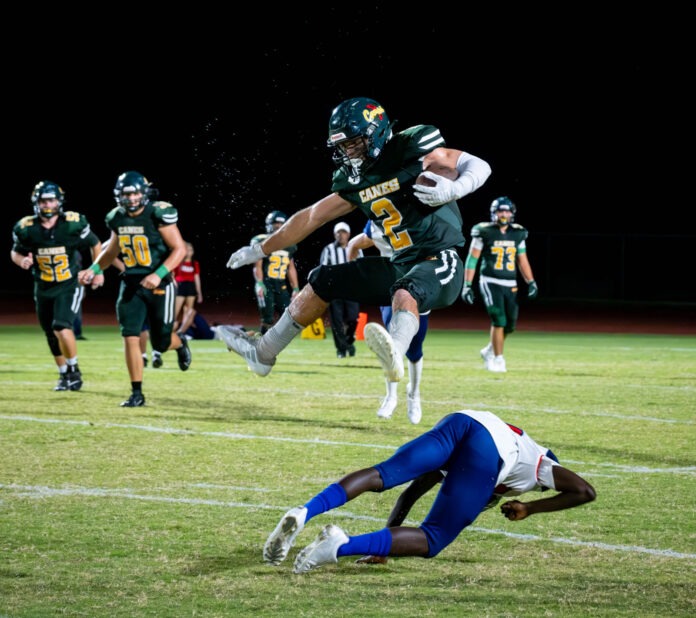 a football player diving for a football during a game