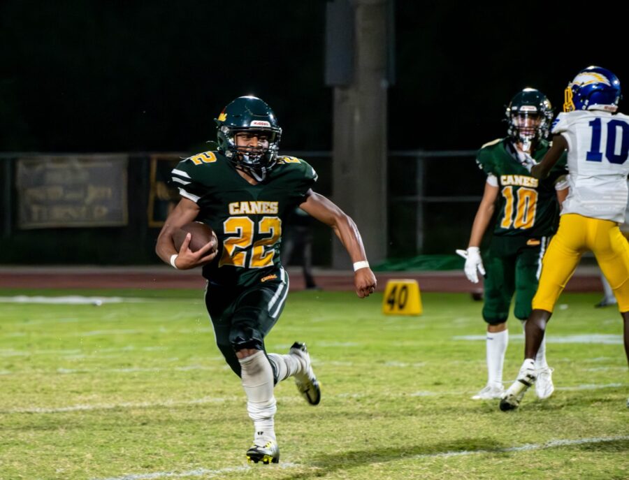 a football player running with the ball during a game