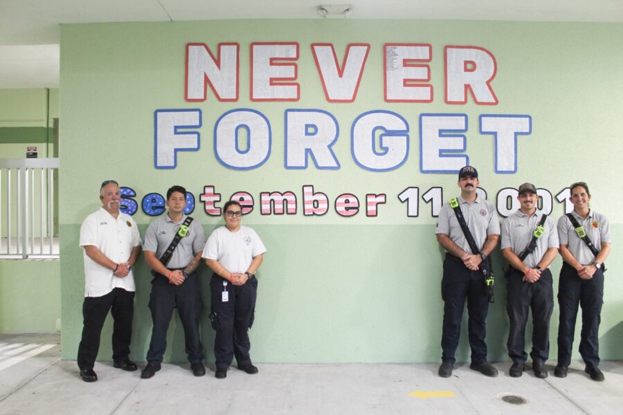 a group of men standing in front of a sign