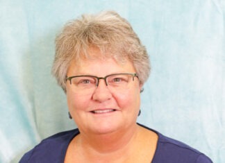 a woman wearing glasses and a blue shirt