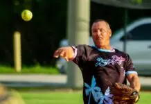 a baseball player throwing a ball on a field