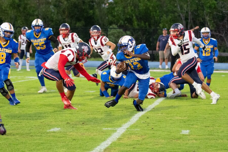 a group of football players playing a game of football