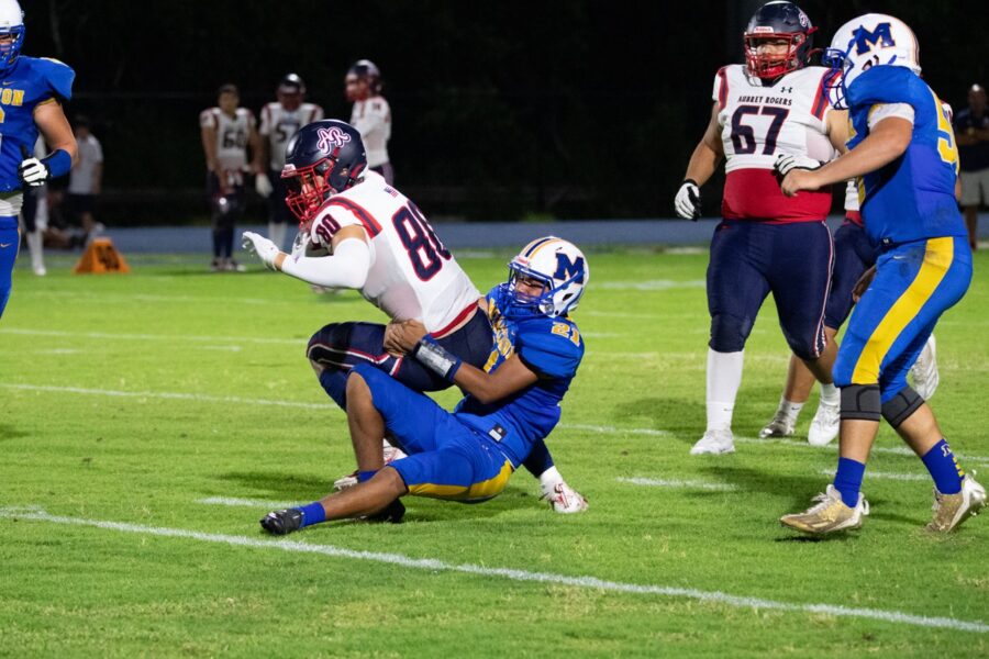 a football player is being tackled by another player