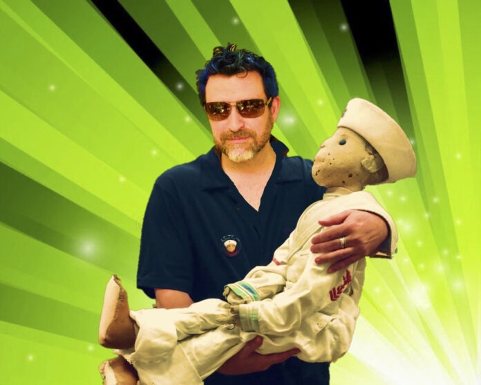 a man holding a stuffed animal in front of a green background