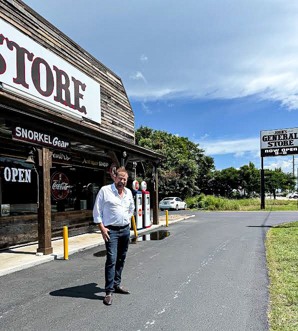 a man walking down the street in front of a store