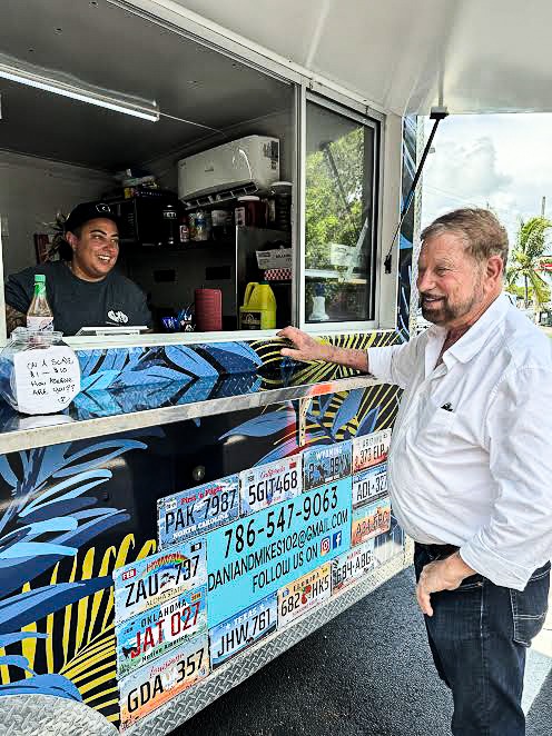 a man standing in front of a food truck