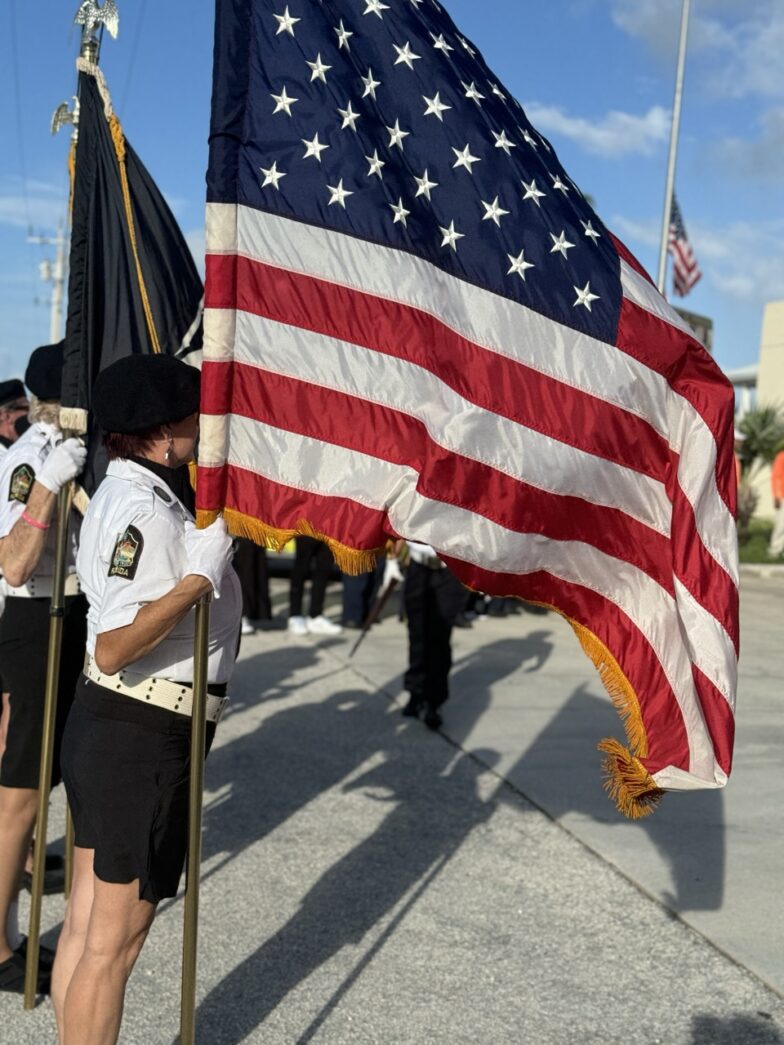 a group of people standing around a flag