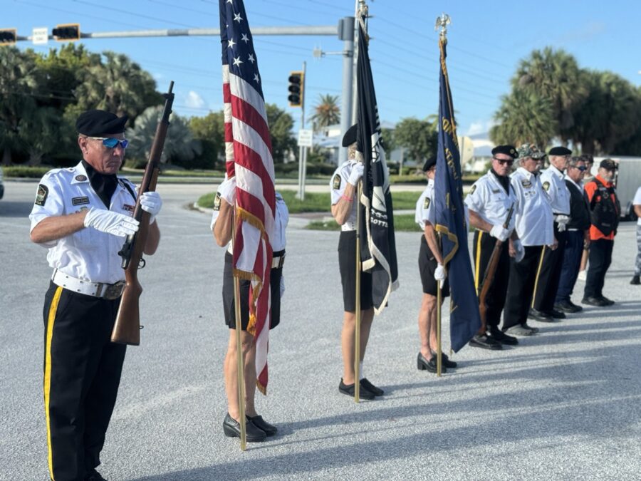 a group of men standing next to each other holding flags