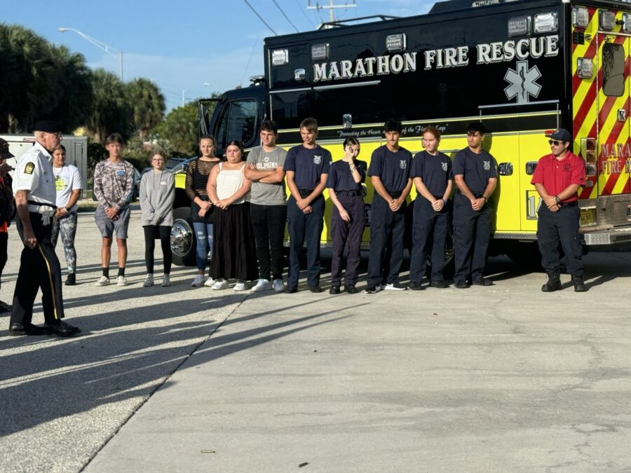 a group of people standing in front of a fire truck