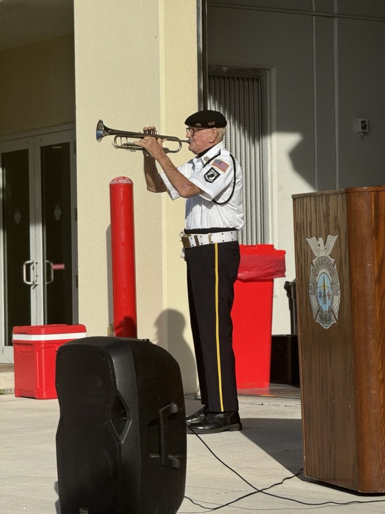 a man in uniform playing a trumpet in front of a podium