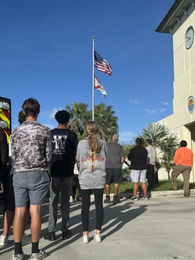 a group of people standing in front of a fire truck