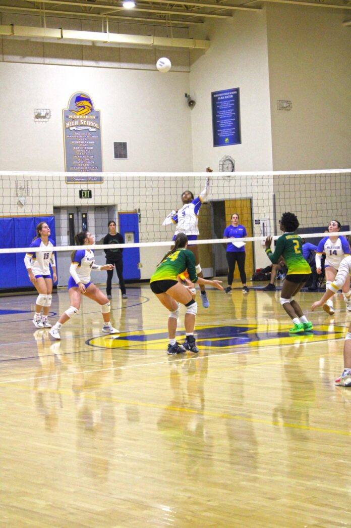 a group of young people playing a game of volleyball