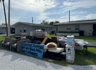 a pile of furniture sitting on the side of a road