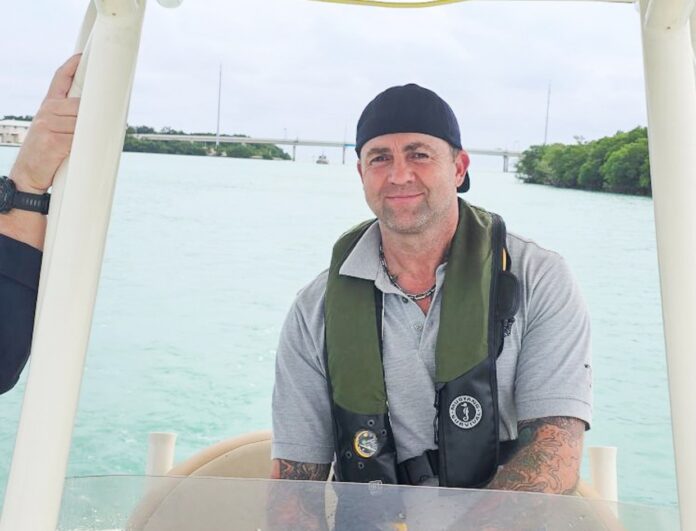 a man sitting on a boat in the water