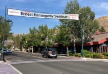 a street with a sign and cars on it