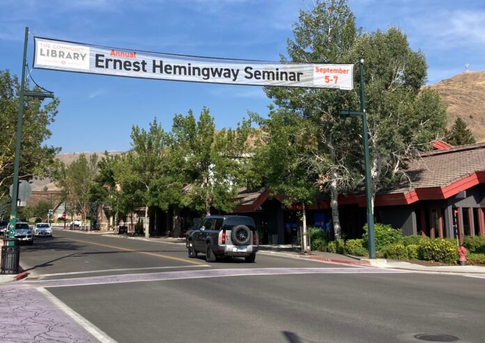 a street with a sign and cars on it