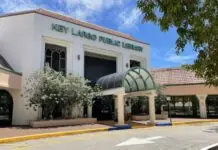 a large white building with a green roof