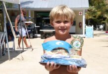 a young boy holding a trophy in his hands