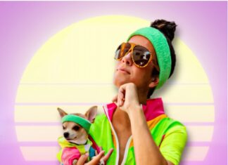 a woman sitting on the ground holding a small dog