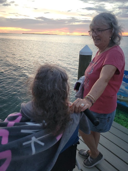 a woman getting a haircut from another woman