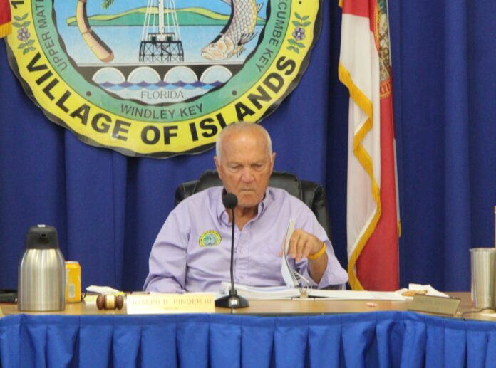 a man sitting at a table with a microphone