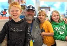 a man and two children are posing for a picture