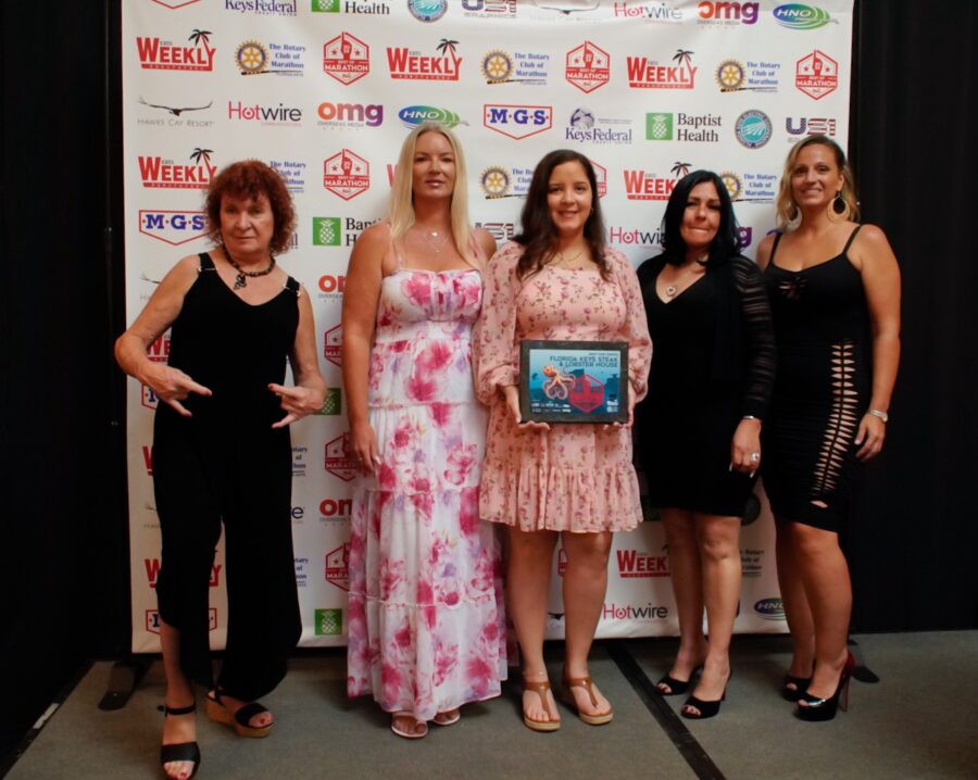 a group of women standing next to each other