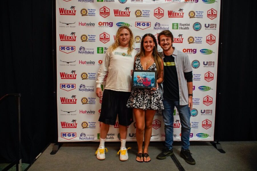 a group of people standing in front of a sign