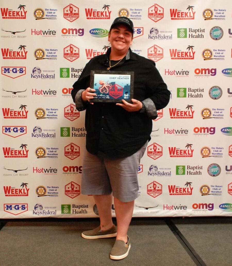 a person standing in front of a wall holding a book