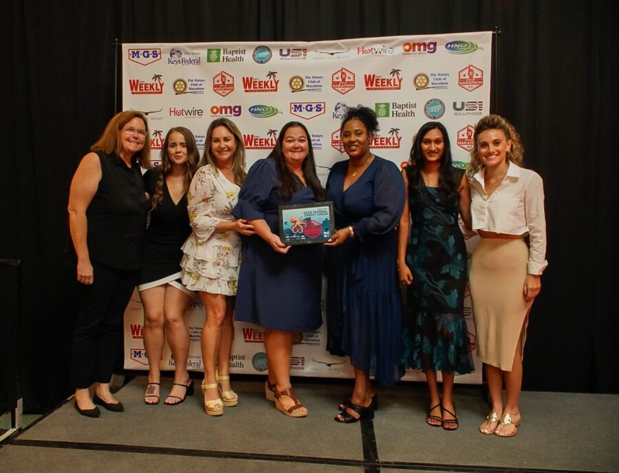 a group of women standing next to each other on a stage