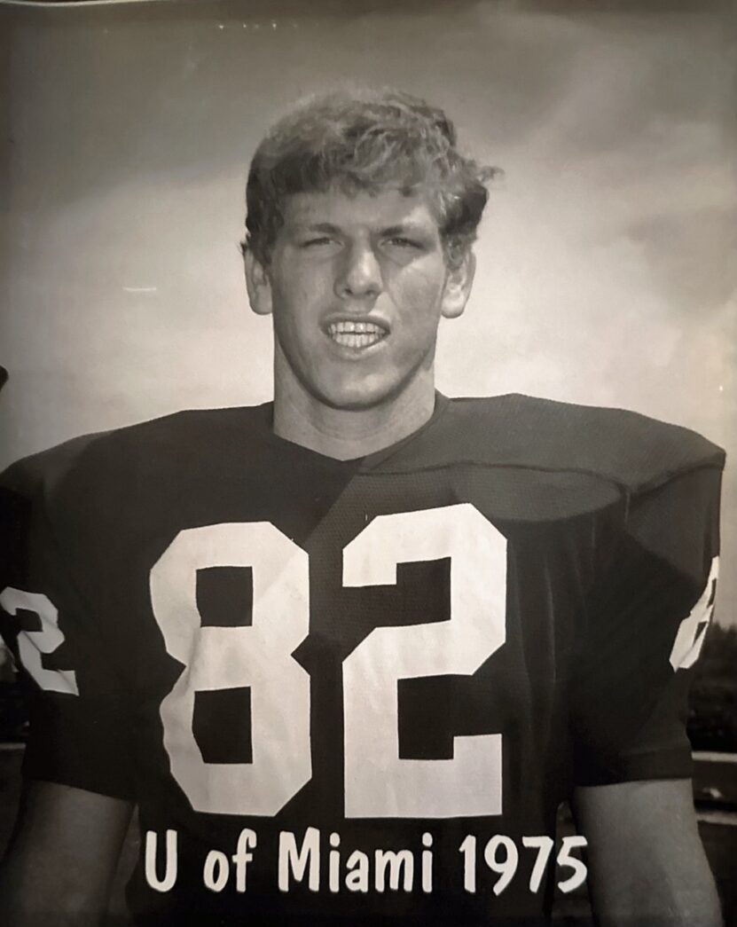 a black and white photo of a football player