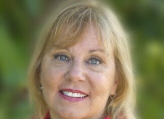 a woman in a red shirt is smiling