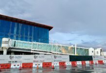 a building under construction with a cloudy sky in the background