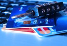 credit cards and a lock on a computer keyboard