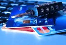 credit cards and a lock on a computer keyboard