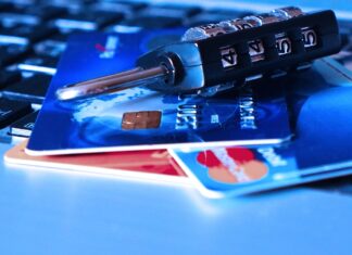 credit cards and a lock on a computer keyboard