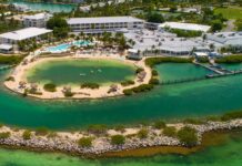 an aerial view of a resort surrounded by water