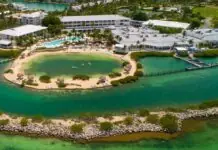 an aerial view of a resort surrounded by water