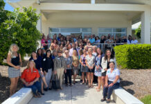 a group of people standing in front of a house