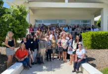 a group of people standing in front of a house