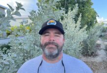 a man with a beard wearing a hat