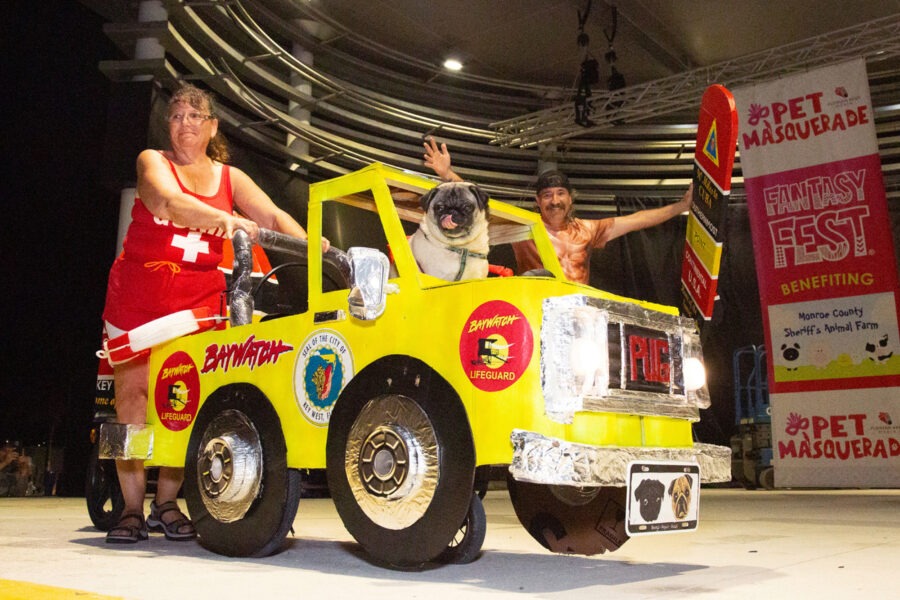 a man and a woman standing in front of a fire truck