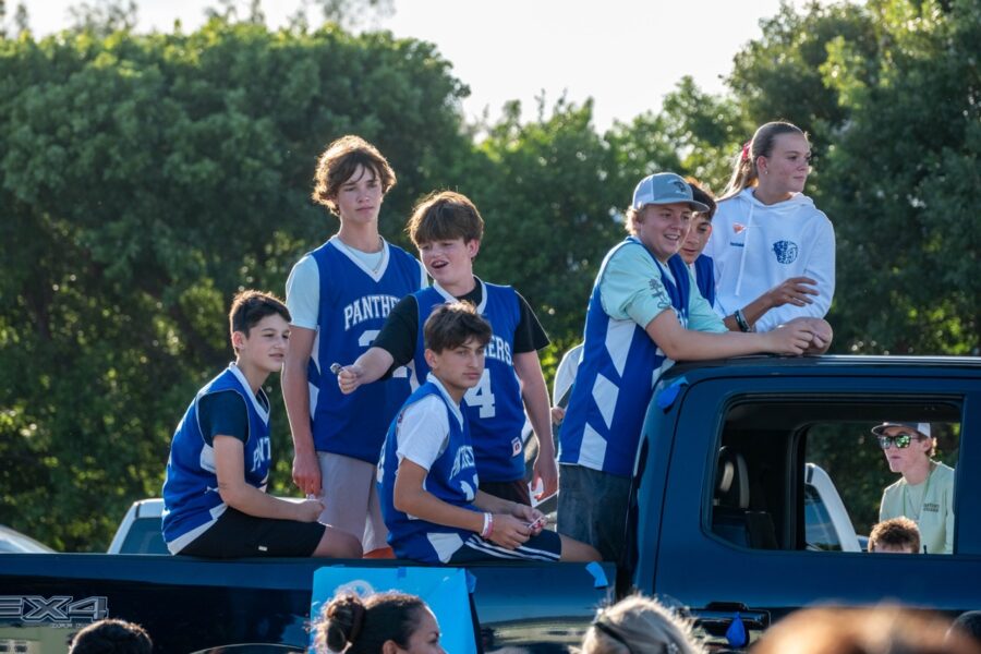 a group of people standing on the back of a truck