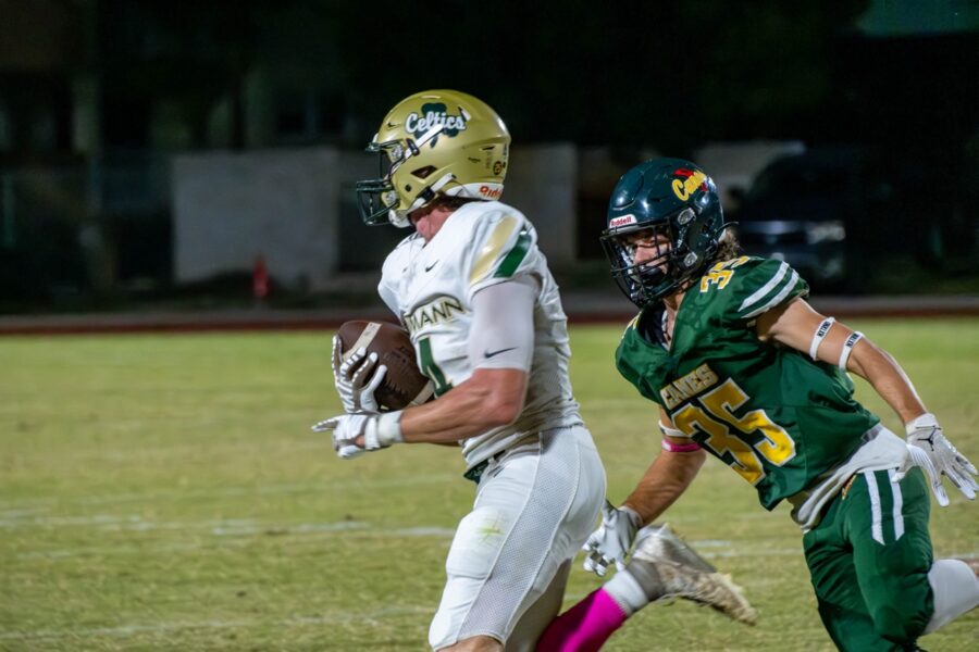 a football player is running with the ball