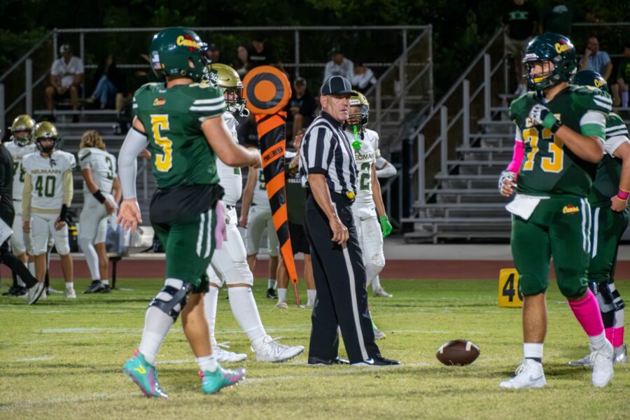 a group of football players standing on top of a field