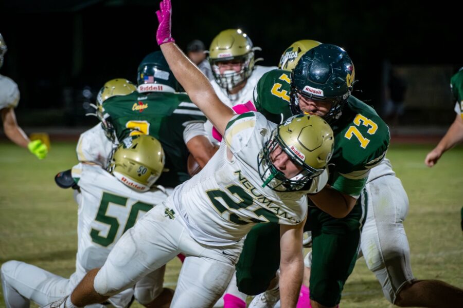 a group of football players playing a game of football