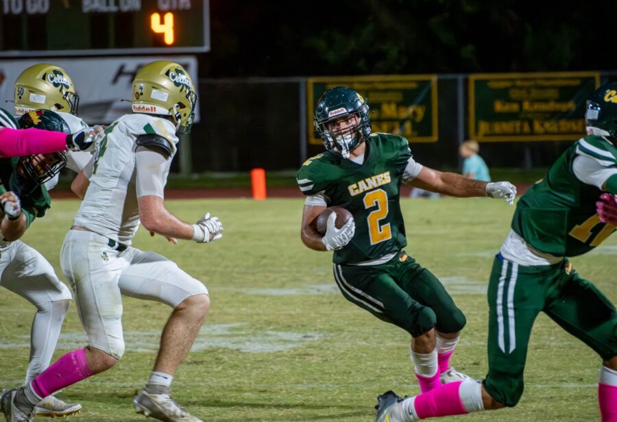 a football player running with the ball during a game