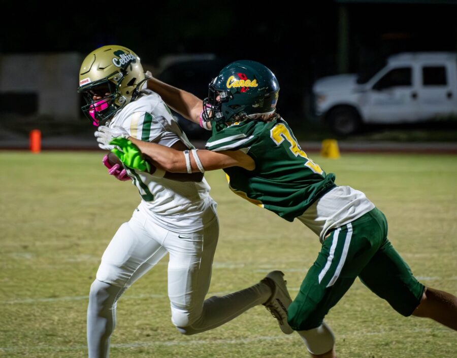 a couple of young men playing a game of football