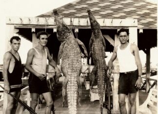 a group of men standing next to each other on a dock