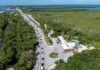 an aerial view of a road and a body of water